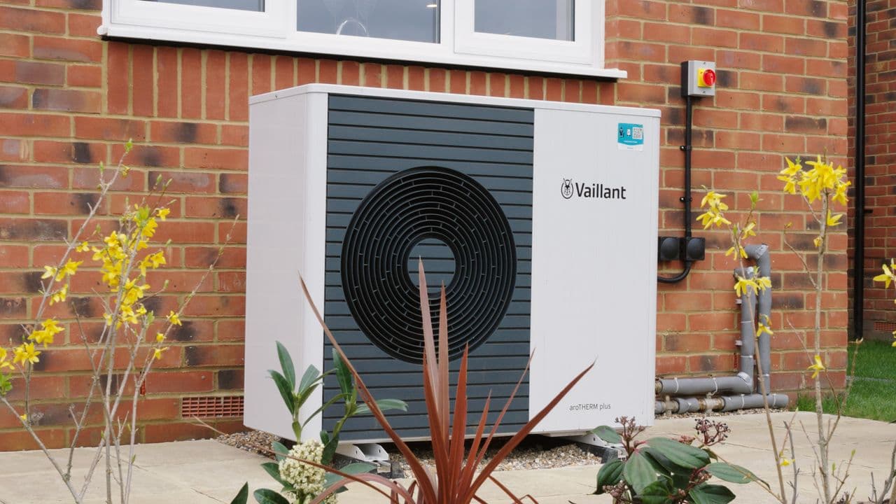Air source heat pump unit installed outside a modern home